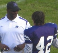 Football athlete speaking with youth coach